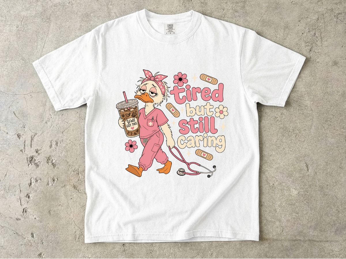 T-Shirt — "Tired But Still Caring" Nurse Duck Graphic Tee