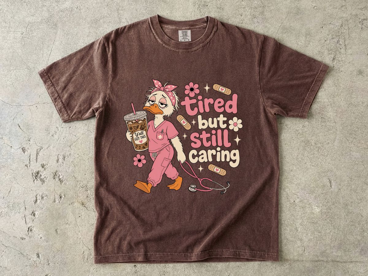T-Shirt — "Tired But Still Caring" Nurse Duck Graphic Tee