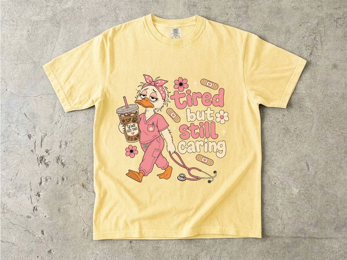 T-Shirt — "Tired But Still Caring" Nurse Duck Graphic Tee