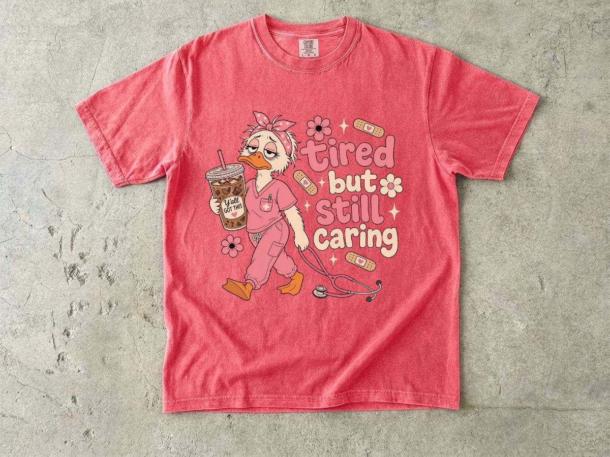 T-Shirt — "Tired But Still Caring" Nurse Duck Graphic Tee