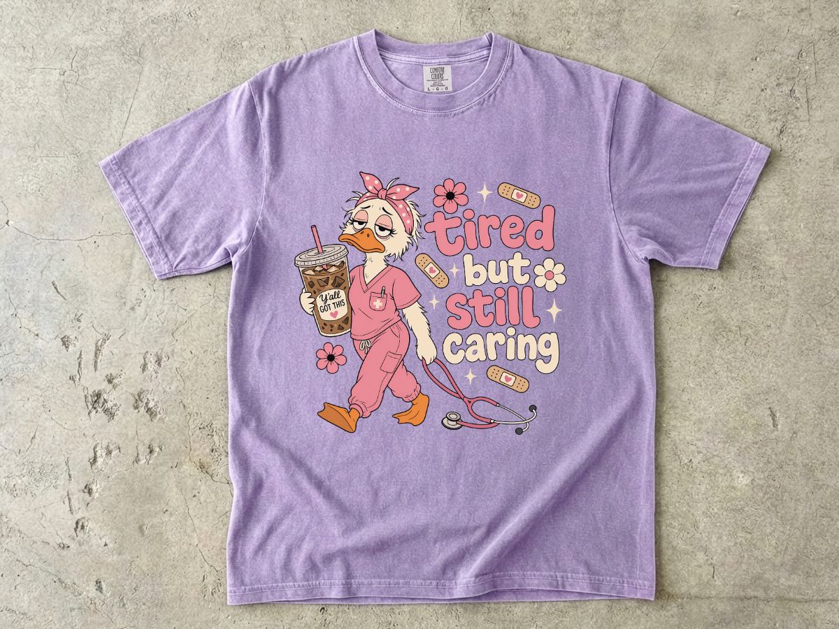 T-Shirt — "Tired But Still Caring" Nurse Duck Graphic Tee