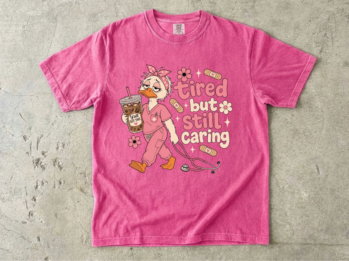 T-Shirt — "Tired But Still Caring" Nurse Duck Graphic Tee