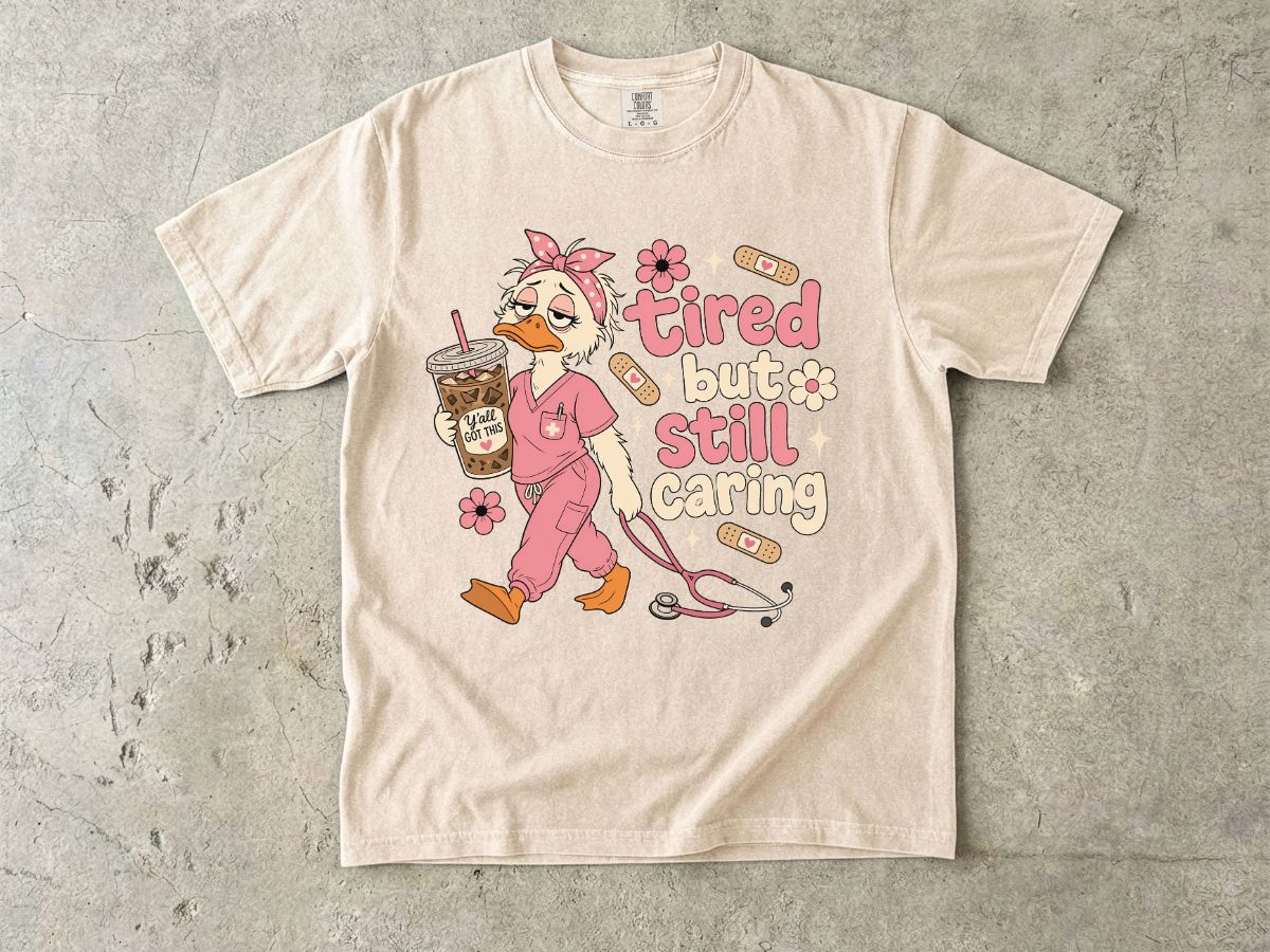 T-Shirt — "Tired But Still Caring" Nurse Duck Graphic Tee