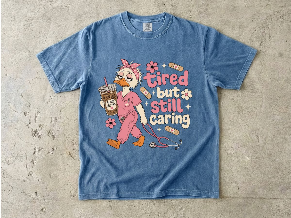 T-Shirt — "Tired But Still Caring" Nurse Duck Graphic Tee