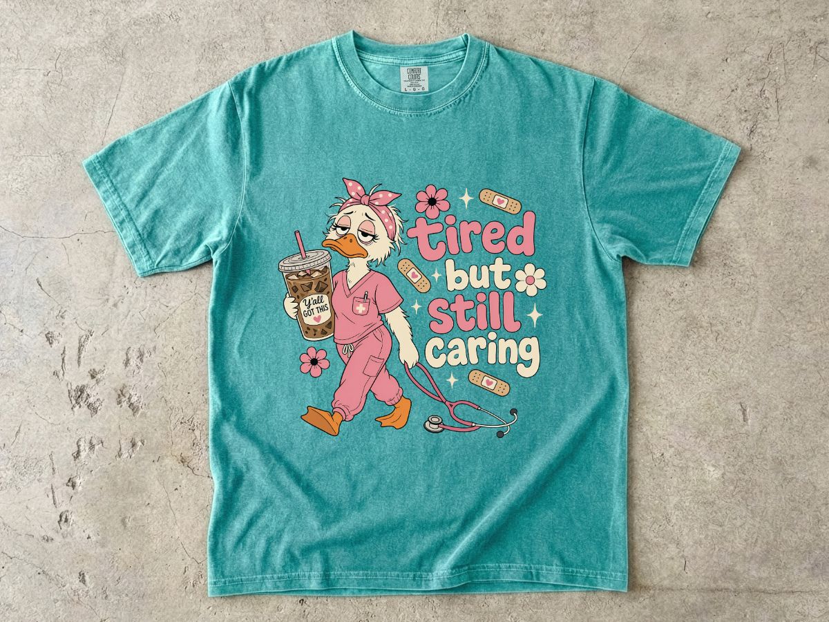 T-Shirt — "Tired But Still Caring" Nurse Duck Graphic Tee