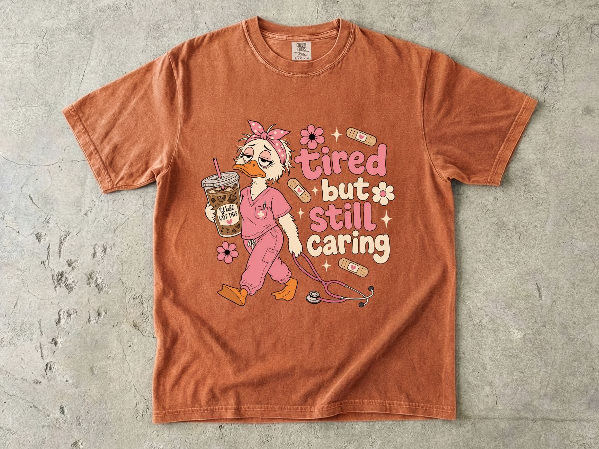T-Shirt — "Tired But Still Caring" Nurse Duck Graphic Tee
