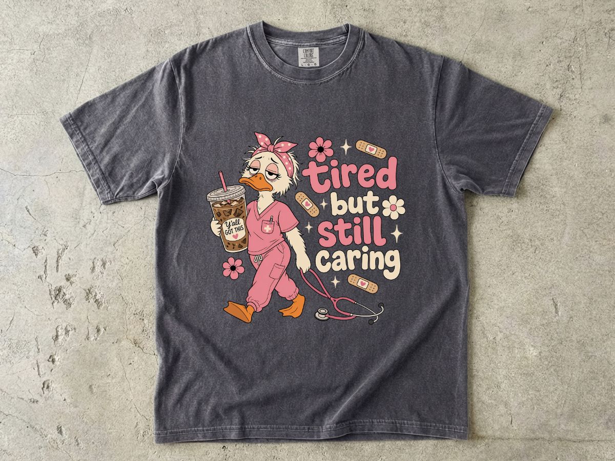 T-Shirt — "Tired But Still Caring" Nurse Duck Graphic Tee