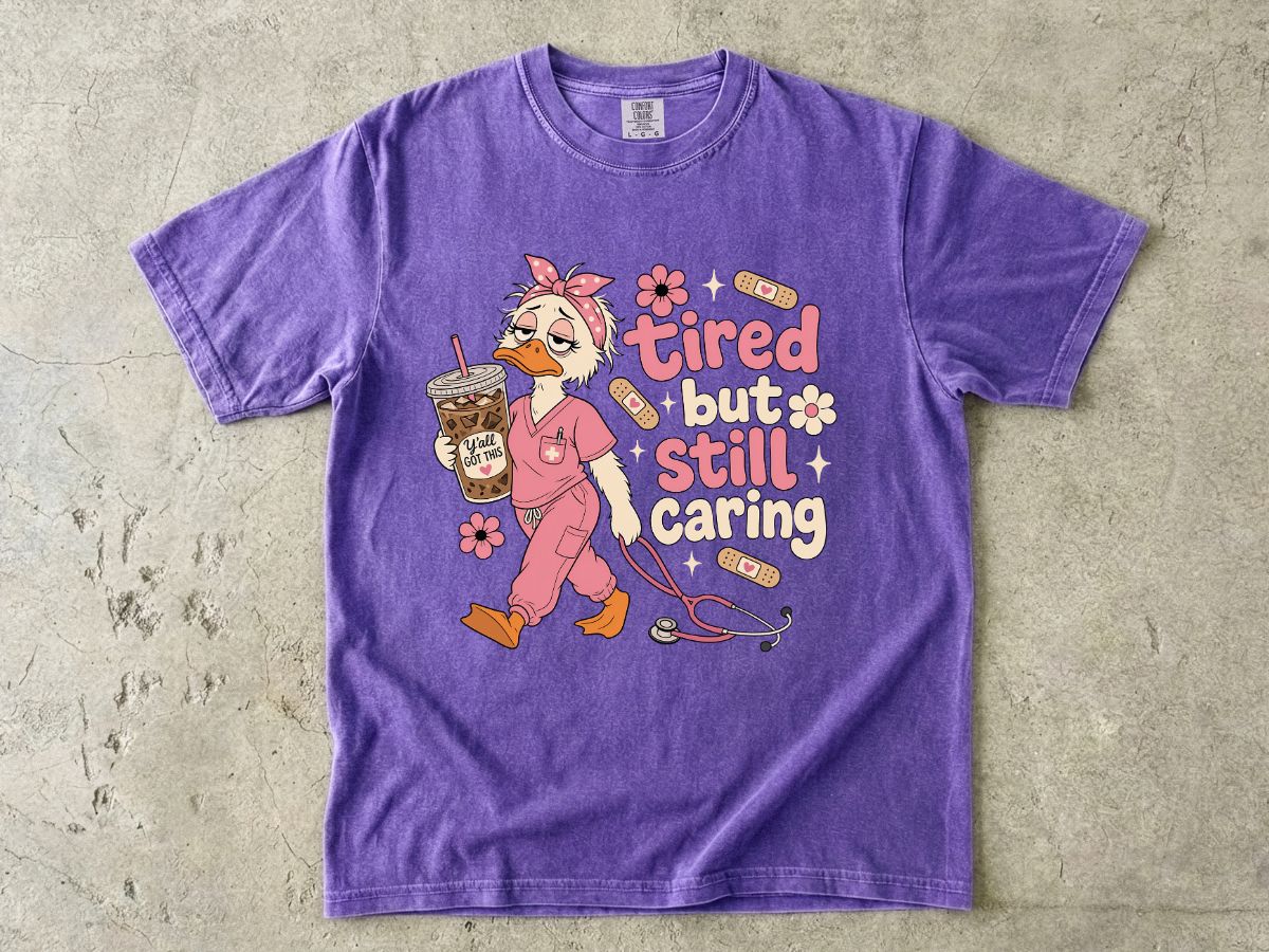 T-Shirt — "Tired But Still Caring" Nurse Duck Graphic Tee