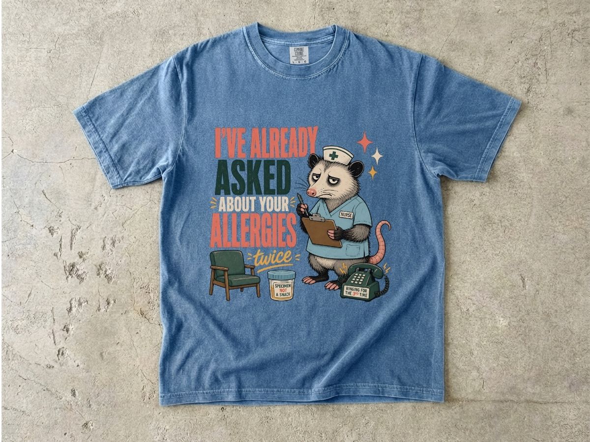 T‑Shirt — "I've Already Asked About Your Allergies Twice" Nurse Possum Graphic