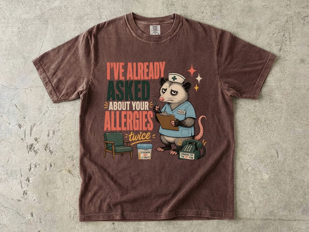 T‑Shirt — "I've Already Asked About Your Allergies Twice" Nurse Possum Graphic