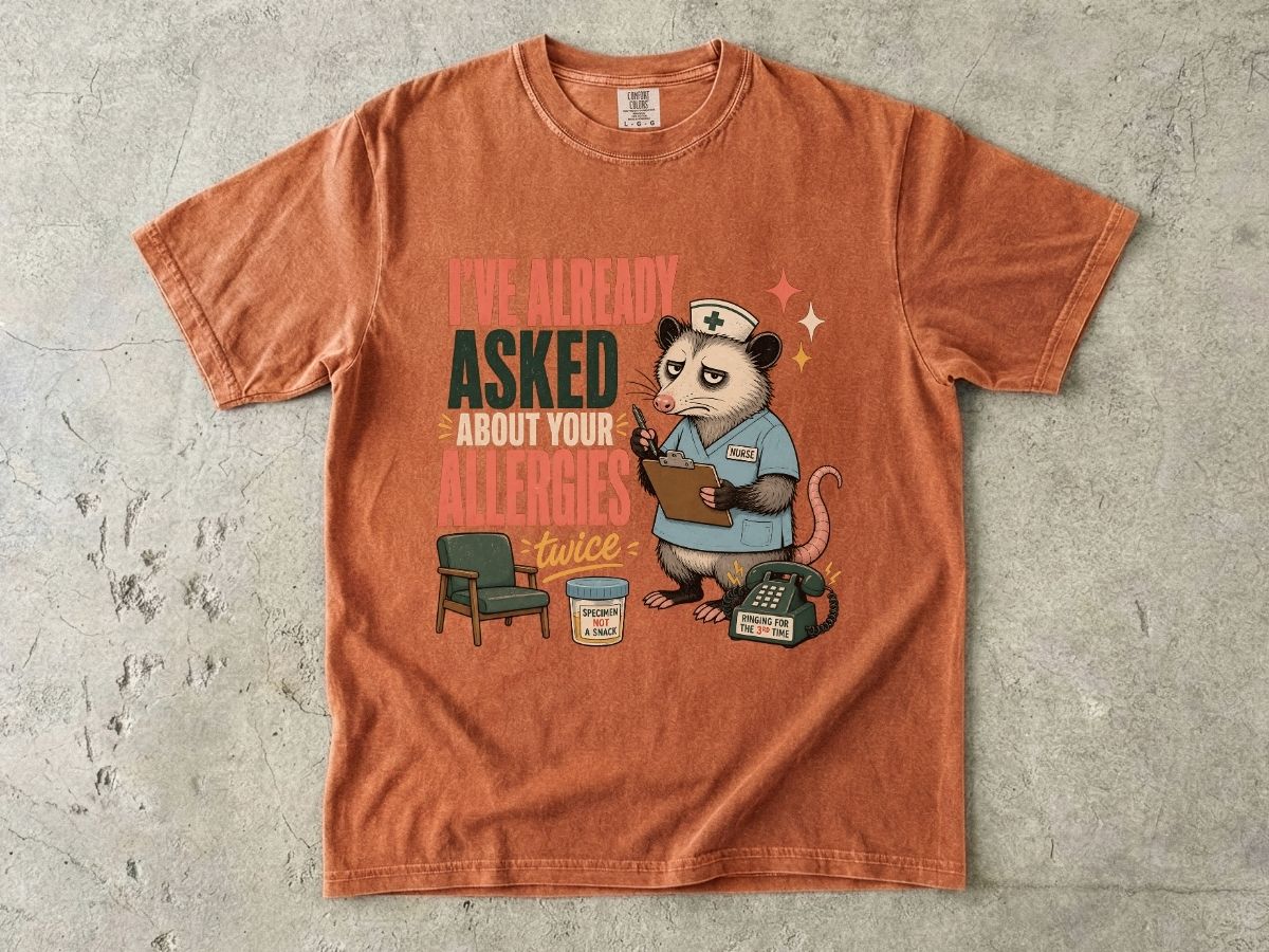 T‑Shirt — "I've Already Asked About Your Allergies Twice" Nurse Possum Graphic