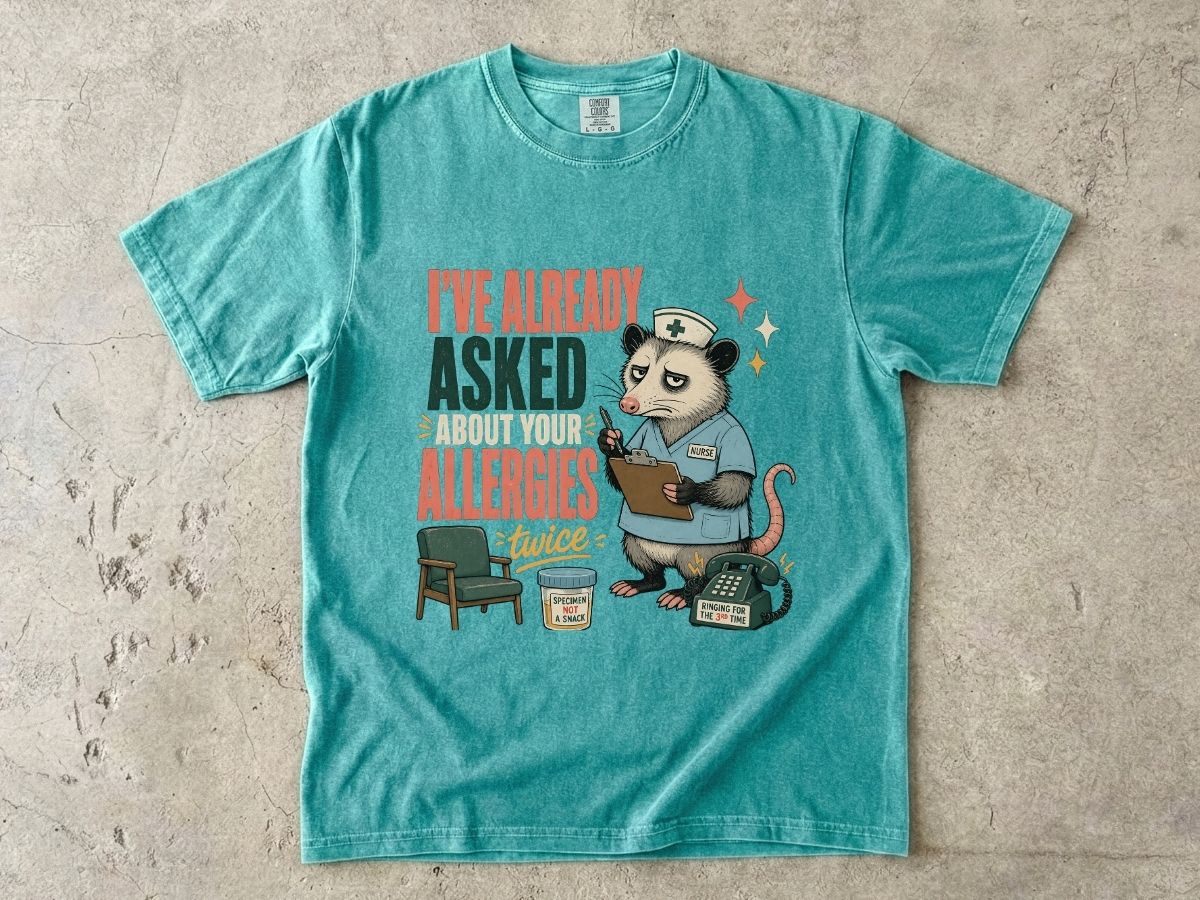 T‑Shirt — "I've Already Asked About Your Allergies Twice" Nurse Possum Graphic