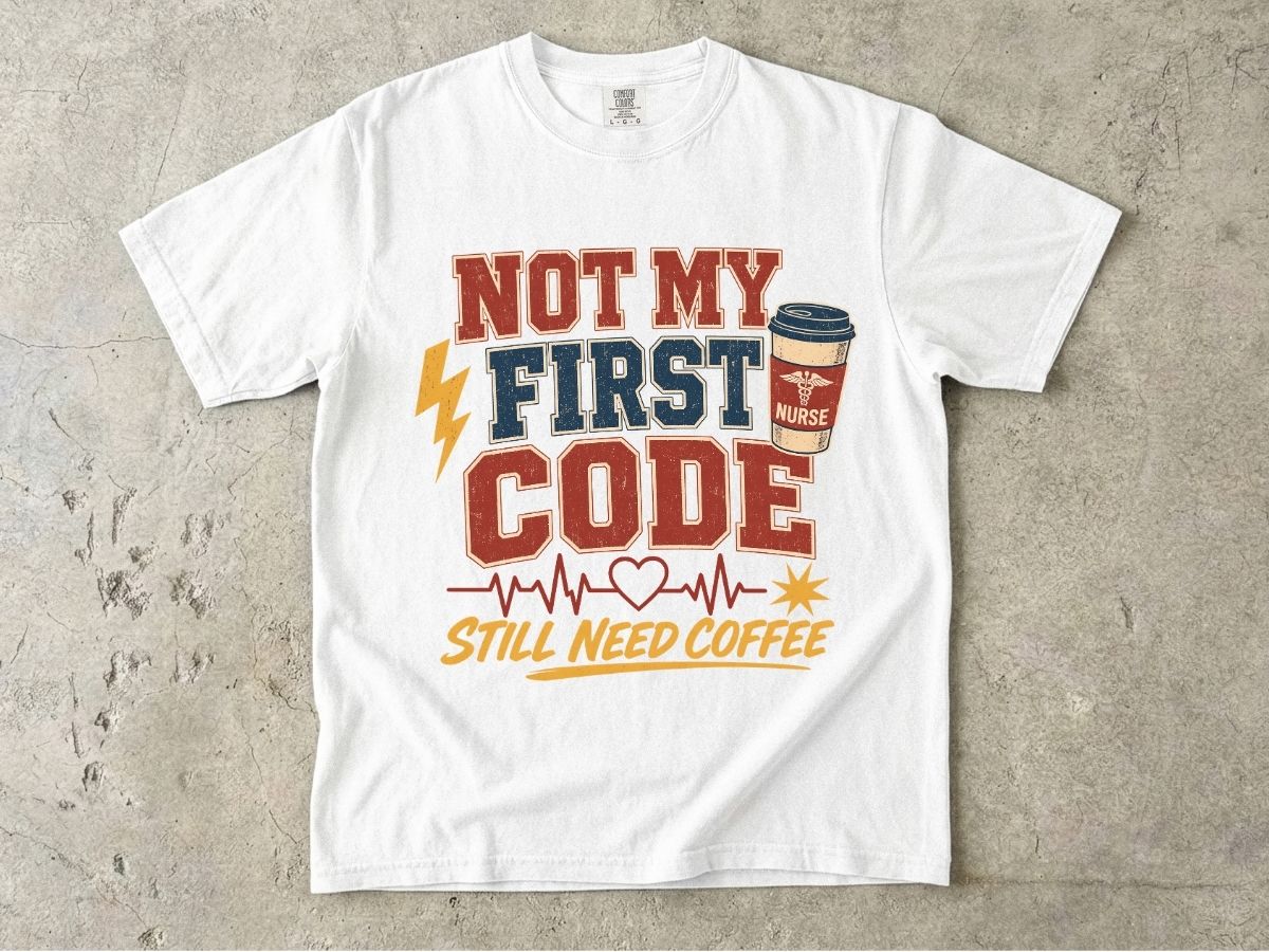 "Not My First Code, Still Need Coffee" bold retro Comfort Colors tee. Funny ER/ICU nurse gift shirt.