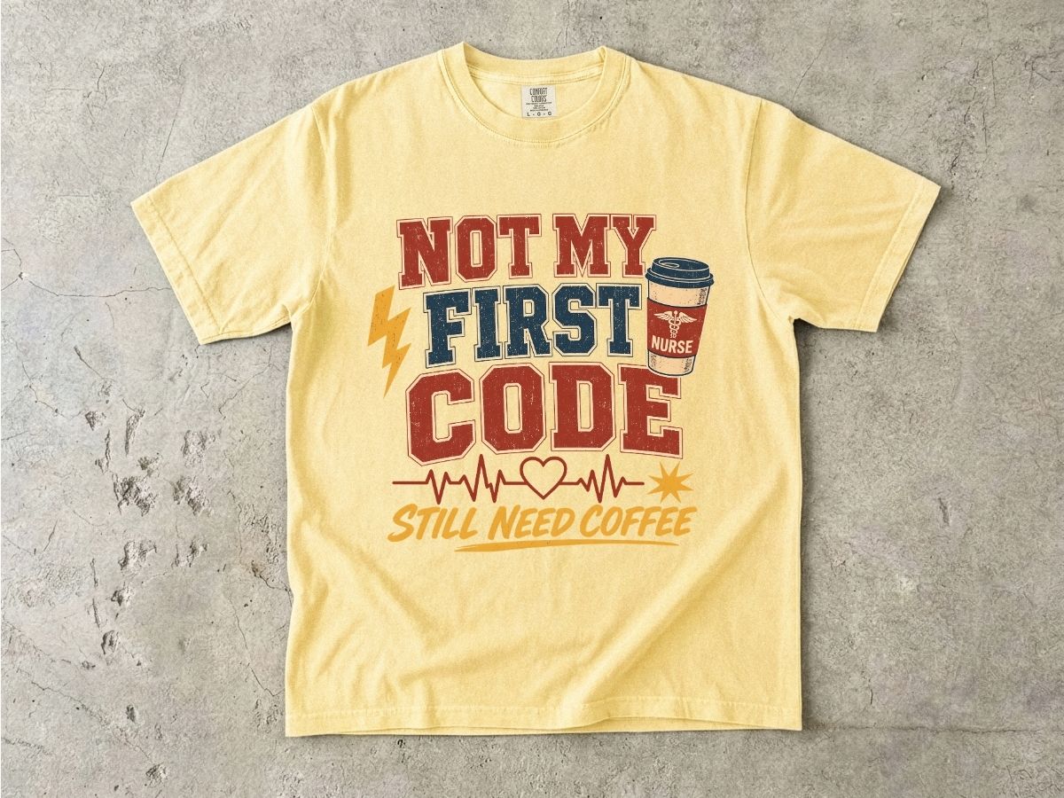"Not My First Code, Still Need Coffee" bold retro Comfort Colors tee. Funny ER/ICU nurse gift shirt.