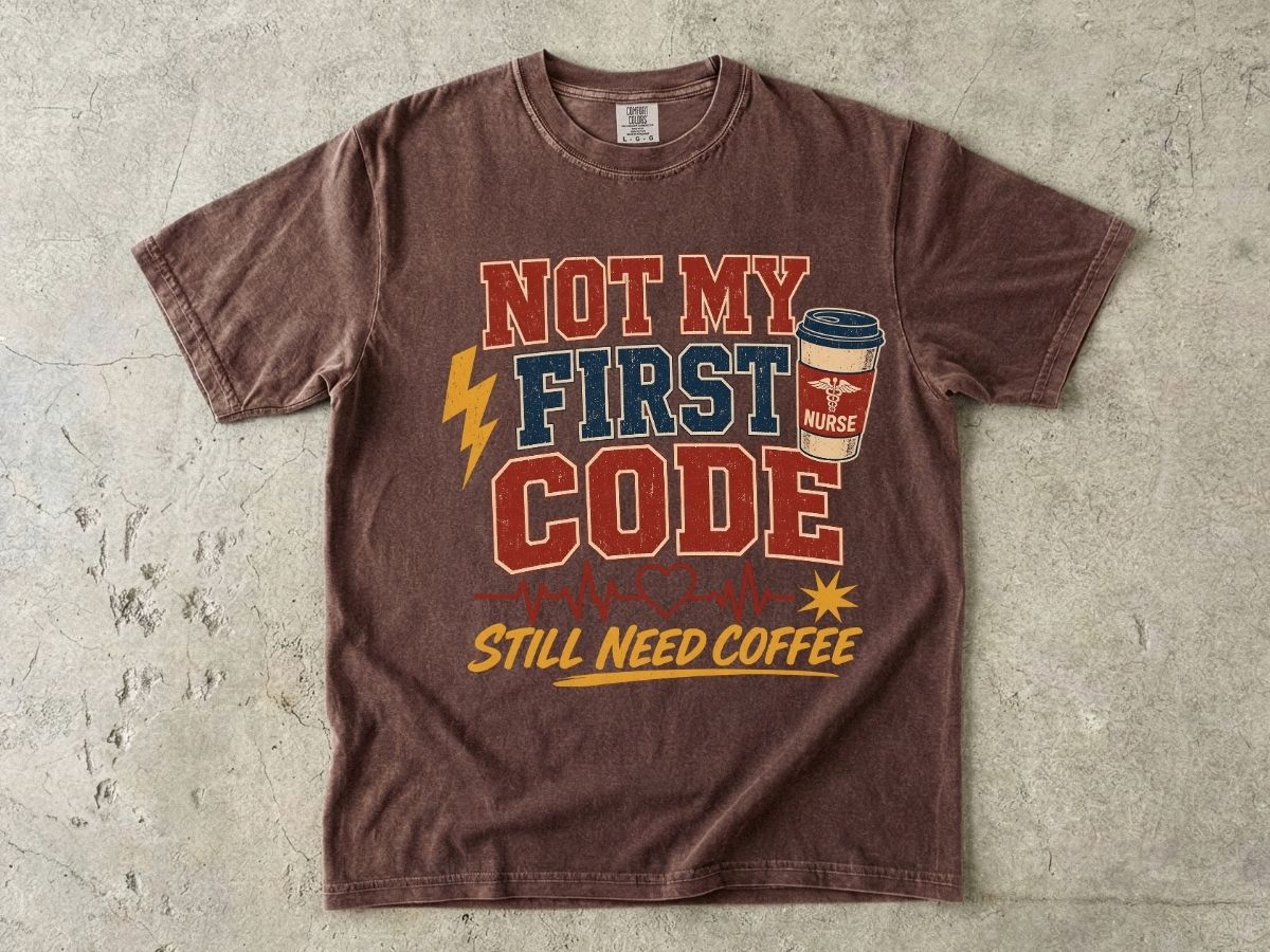 "Not My First Code, Still Need Coffee" bold retro Comfort Colors tee. Funny ER/ICU nurse gift shirt.