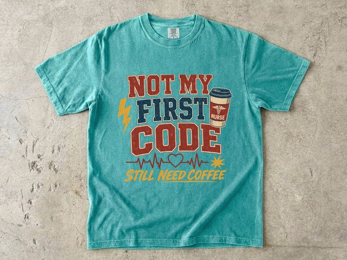 "Not My First Code, Still Need Coffee" bold retro Comfort Colors tee. Funny ER/ICU nurse gift shirt.