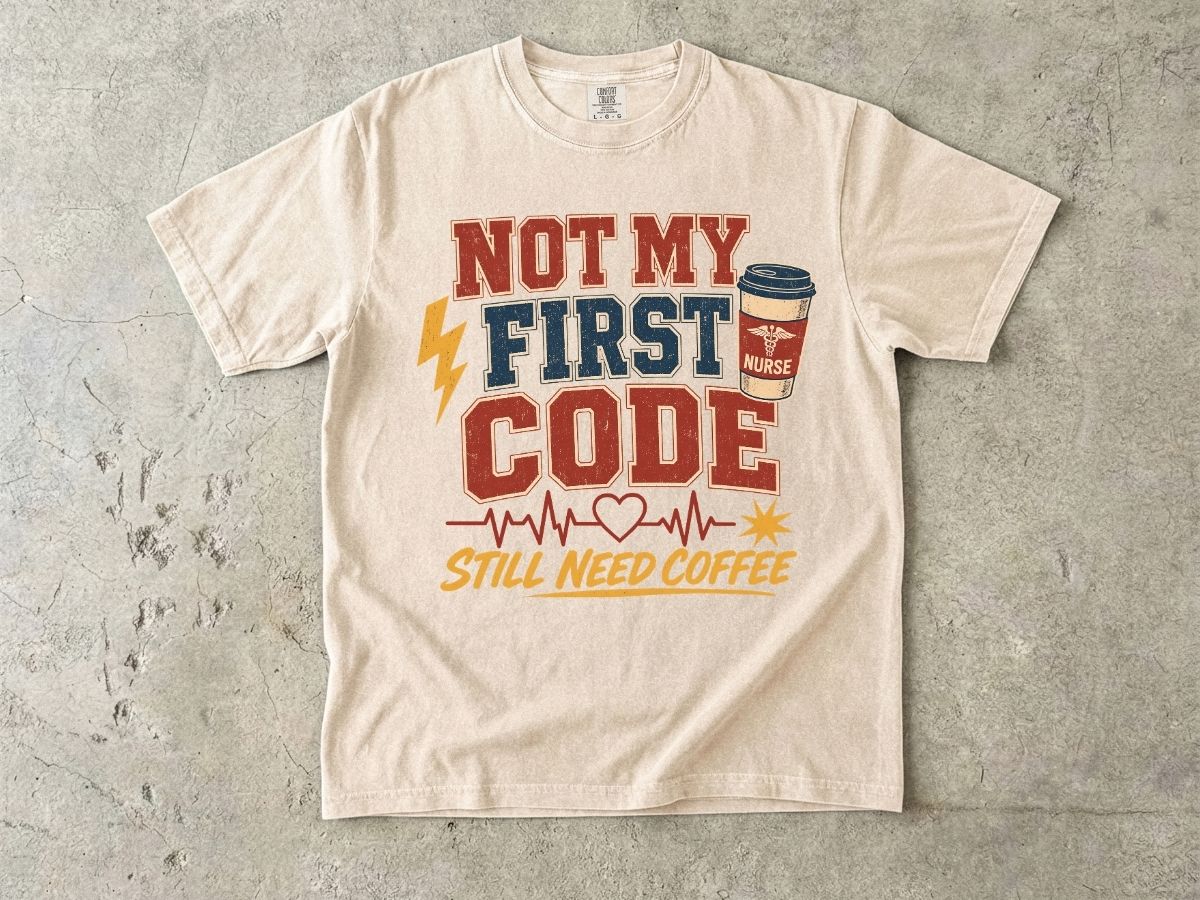 "Not My First Code, Still Need Coffee" bold retro Comfort Colors tee. Funny ER/ICU nurse gift shirt.