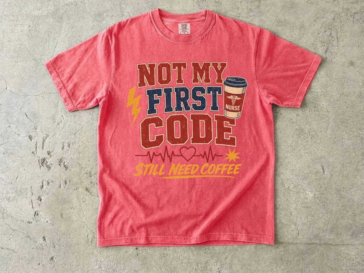 "Not My First Code, Still Need Coffee" bold retro Comfort Colors tee. Funny ER/ICU nurse gift shirt.