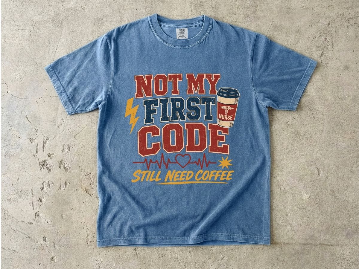 "Not My First Code, Still Need Coffee" bold retro Comfort Colors tee. Funny ER/ICU nurse gift shirt.
