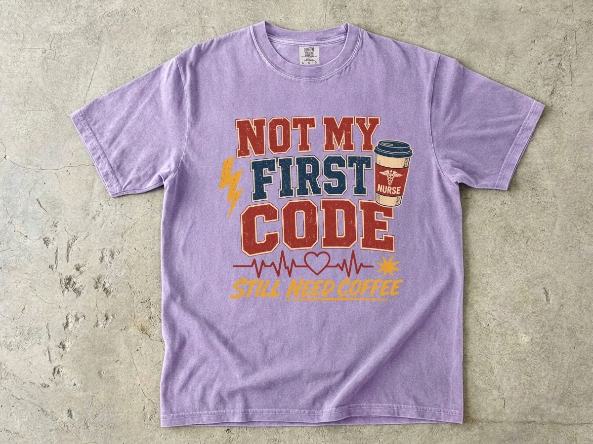 "Not My First Code, Still Need Coffee" bold retro Comfort Colors tee. Funny ER/ICU nurse gift shirt.