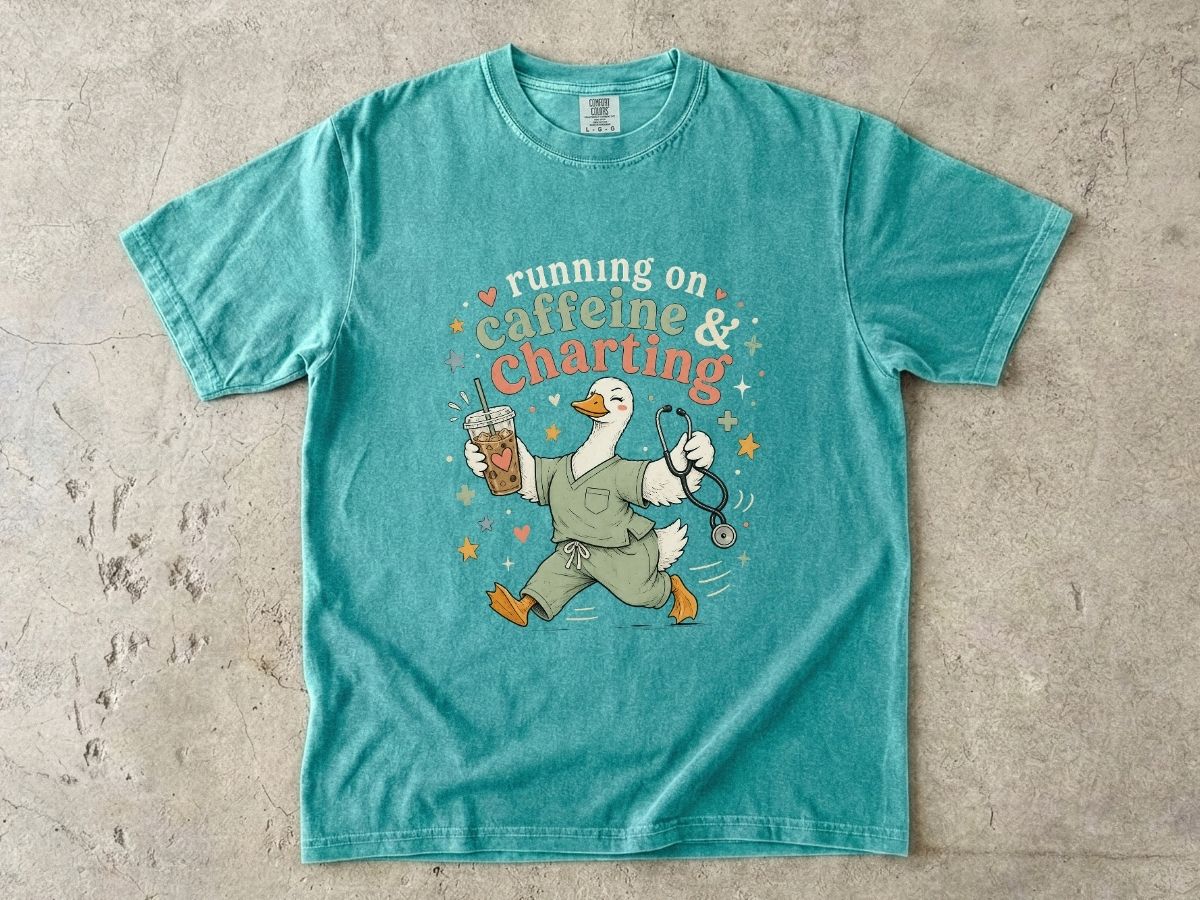 Caffeine & Charting T‑Shirt — Cute Goose Nurse with Coffee Graphic
