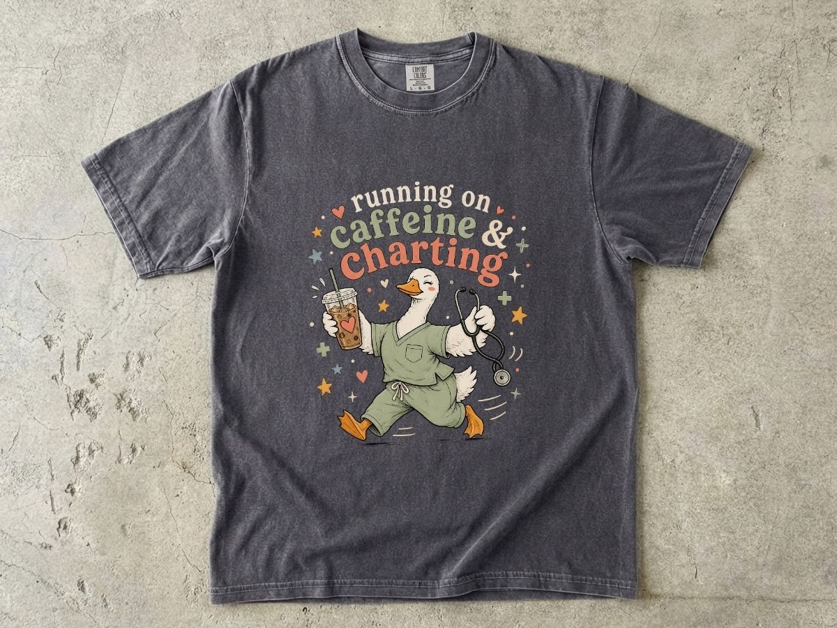 Caffeine & Charting T‑Shirt — Cute Goose Nurse with Coffee Graphic