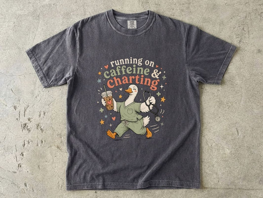 Caffeine & Charting T‑Shirt — Cute Goose Nurse with Coffee Graphic