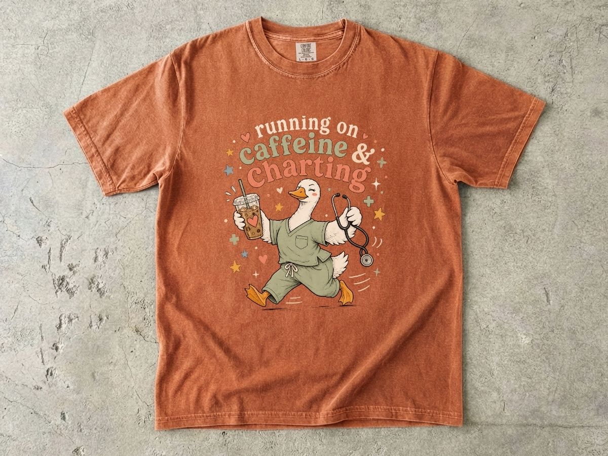Caffeine & Charting T‑Shirt — Cute Goose Nurse with Coffee Graphic