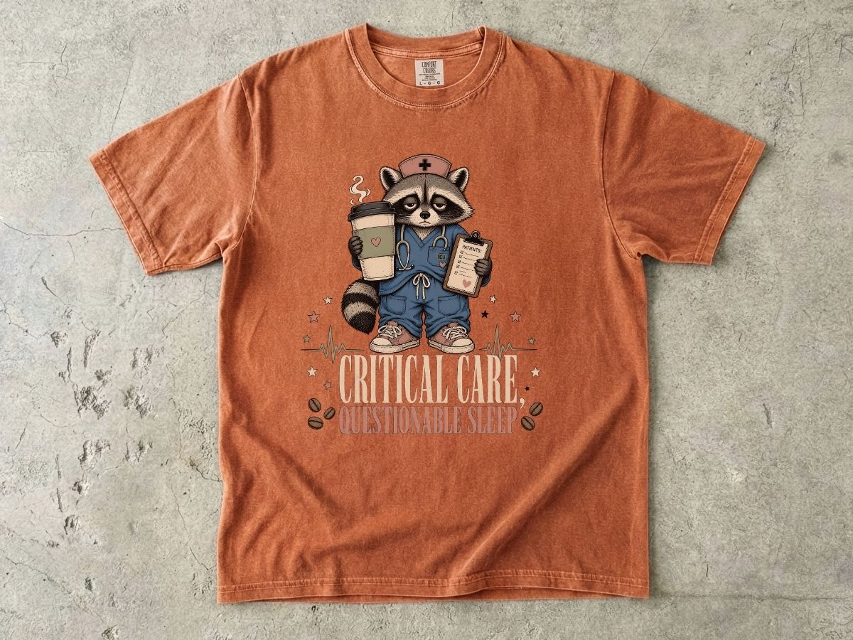 T‑Shirt — "Critical Care, Questionable Sleep" Raccoon Nurse Graphic Tee