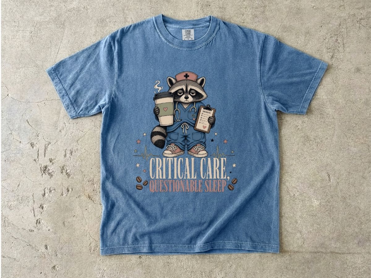T‑Shirt — "Critical Care, Questionable Sleep" Raccoon Nurse Graphic Tee