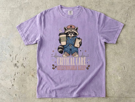 T‑Shirt — "Critical Care, Questionable Sleep" Raccoon Nurse Graphic Tee